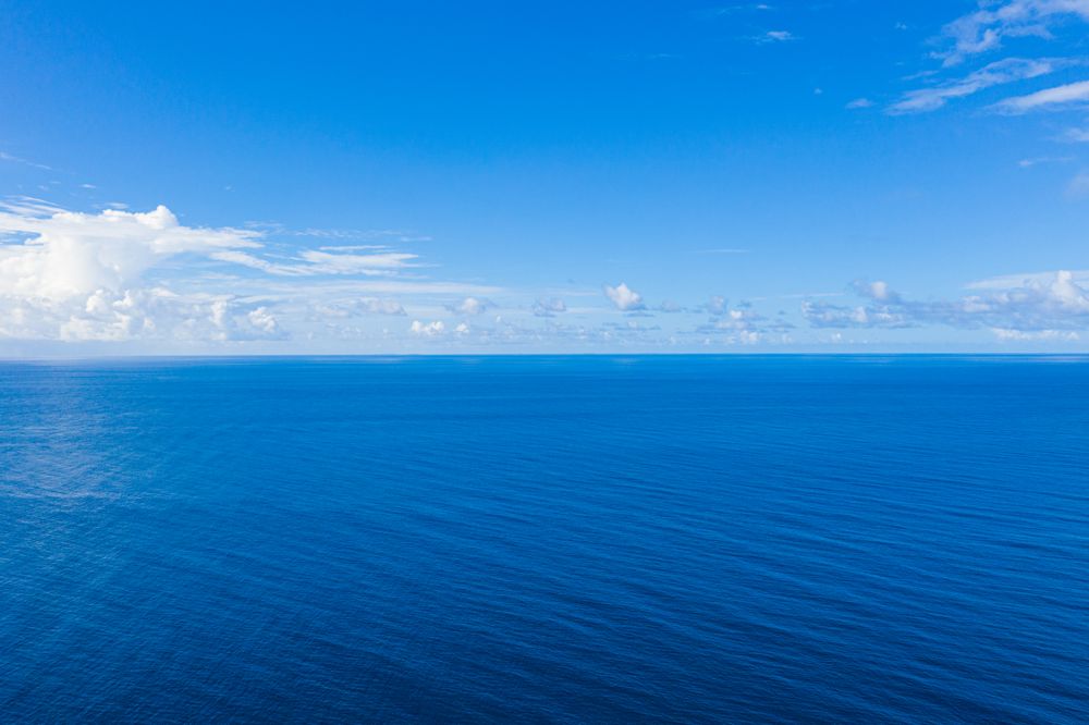 Clear blue Indian Ocean under a blue sky with clouds, landscape