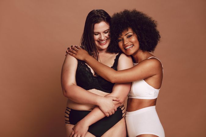 Happy female models smiling and hugging