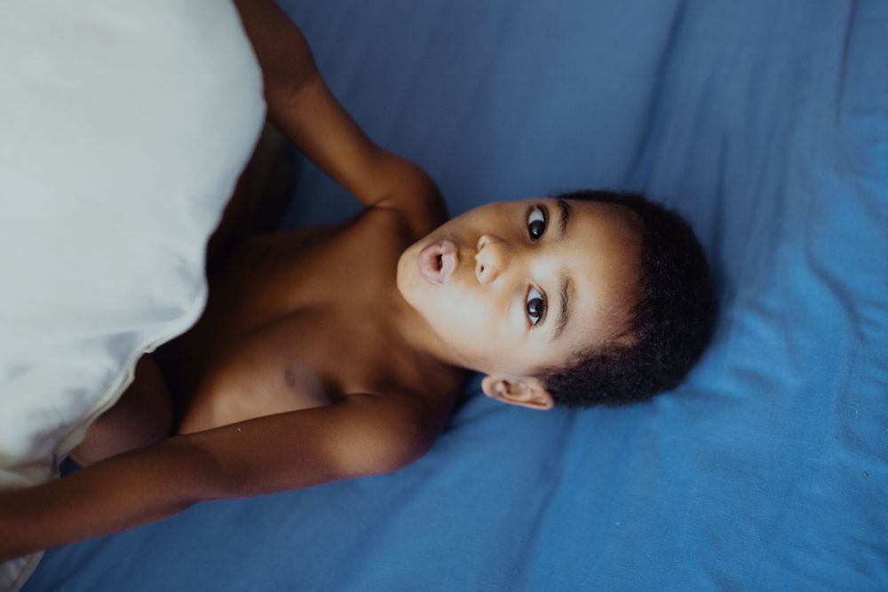 Black boy having fun on bed