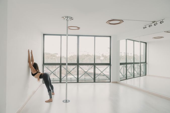 Flexible woman stretching in studio