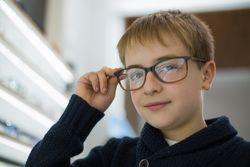 Young boy trying on glasses