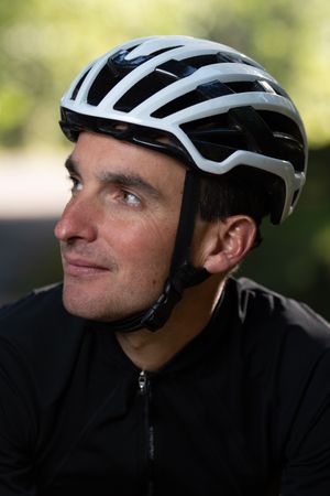 Positive cyclist looking away in park