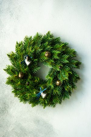 Christmas wreath with ornamental brass bells on marble counter