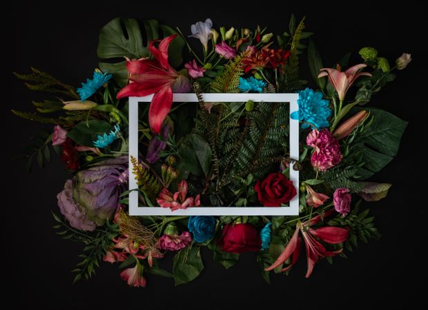 Colorful spring flowers of red, blue, pink, cream around paper square outline