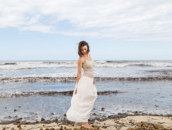 Charming young woman on shore near water