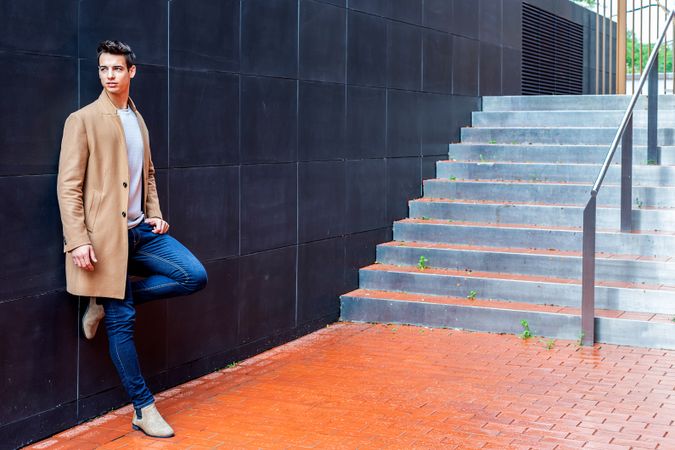 Young man wearing winter coat in the street