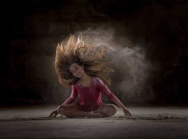 Young woman between fog in darkness