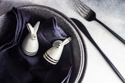 Rabbit figurines on table setting for Easter dinner