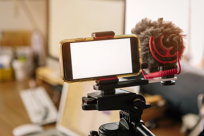Camera attached to microphone on tripod
