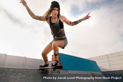 Cool young woman skateboarding at skate park 5ln8vb