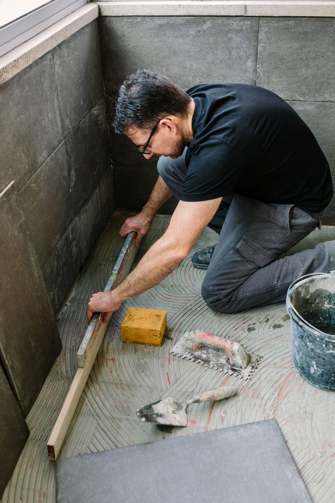 Bricklayer checking floor with a level