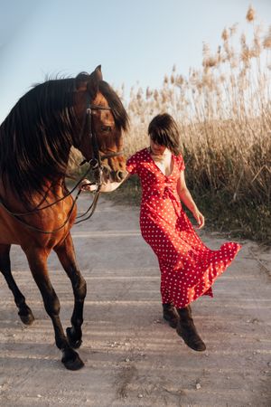 female walking with horse