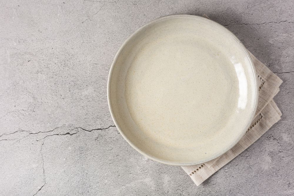 Empty plate on the slate table. Top view of the image.