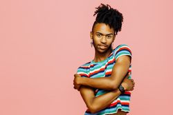 Black man looking at camera with his arms crossed