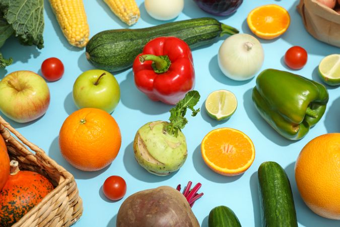 Different vegetables and fruits on blue background. Healthy food