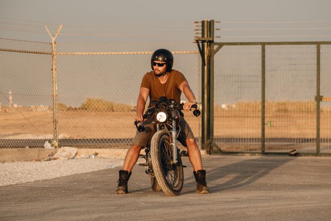 Strong man driving motorcycle