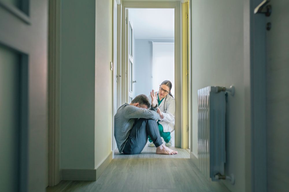 Female doctor trying to help male patient