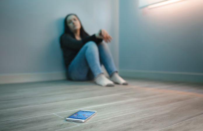 Unrecognizable woman with phone addiction looking at her mobile