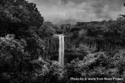 Waterfall surrounded by lush vegetation on cloudy day in monochrome 4ZMY35