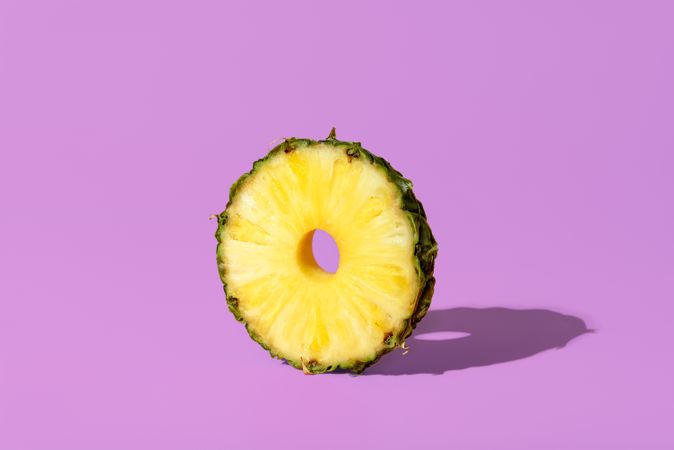 Pineapple slice isolated on a purple background