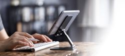 Man working on tablet with keyboard
