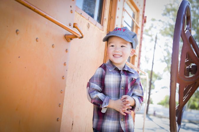 Cute Young  Boy Having Fun on Railroad Car