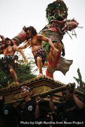 Red statue being carried by men during Hindu prayer ceremony 0WgOW0