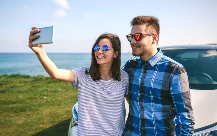 Young couple doing a selfie on the car