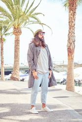 Stylish man walking on embankment