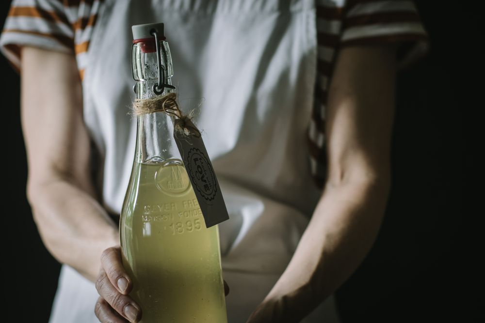 Female with bottle of elderflower syrup