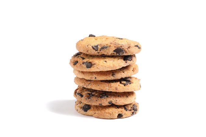 Stack of tasty chocolate chip cookies on blank background