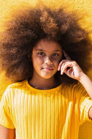 Black girl with Afro hairstyle looking at camera