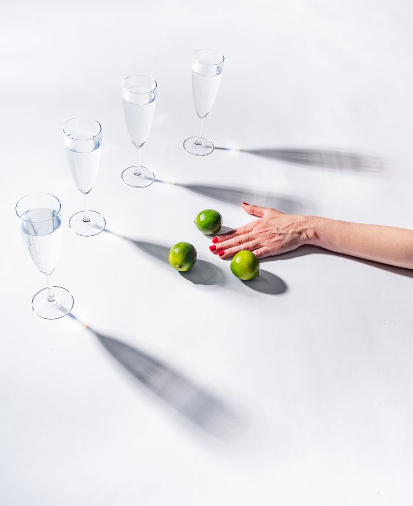 Composition of a hand with citrus and glasses of water