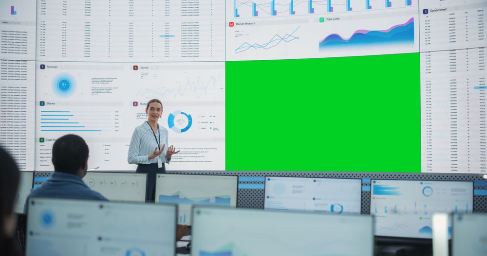 Team Of Deep Learning Company Employees Listening Behind Desktop Computers.