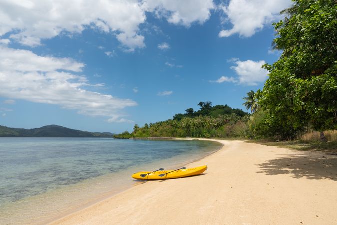 Kayak on sandy beach of tropical shore