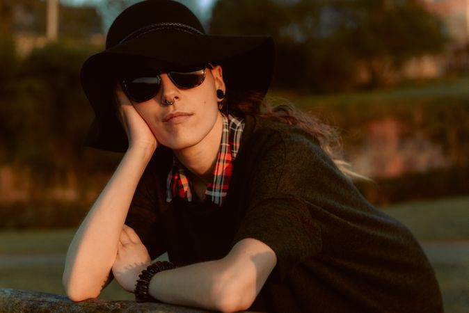 Stylish young woman in felt hat outdoors