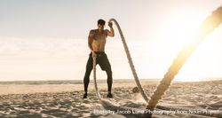 Athletic man doing fitness workout at a beach on a sunny day 5woD65