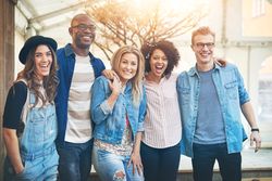 Happy multi-ethnic group of friends standing outside