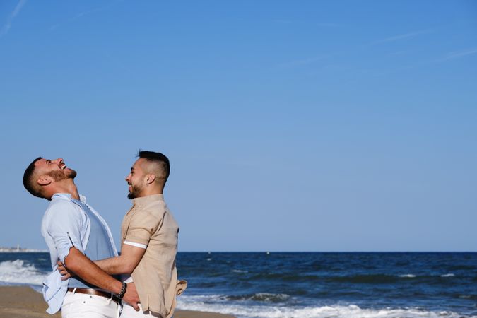 Happy gay couple enjoying and embracing outdoors