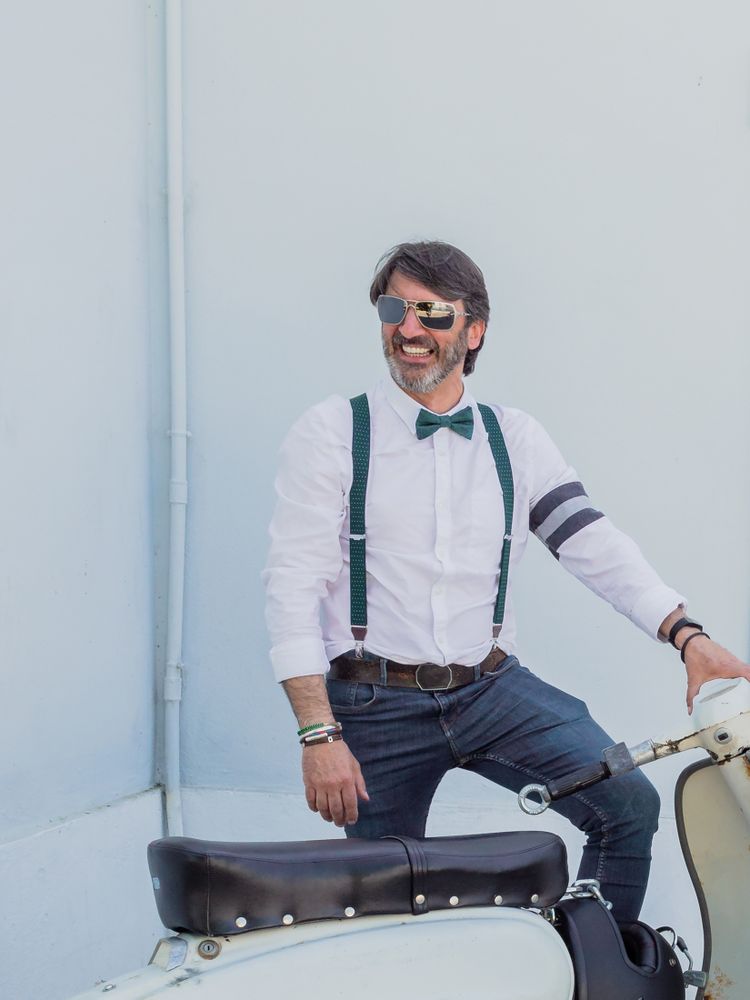 Trendy man sitting on vintage scooter