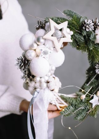 Cropped image of person holding Christmas garland