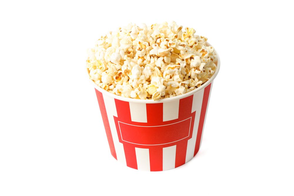 Striped bucket with popcorn isolated on blank background