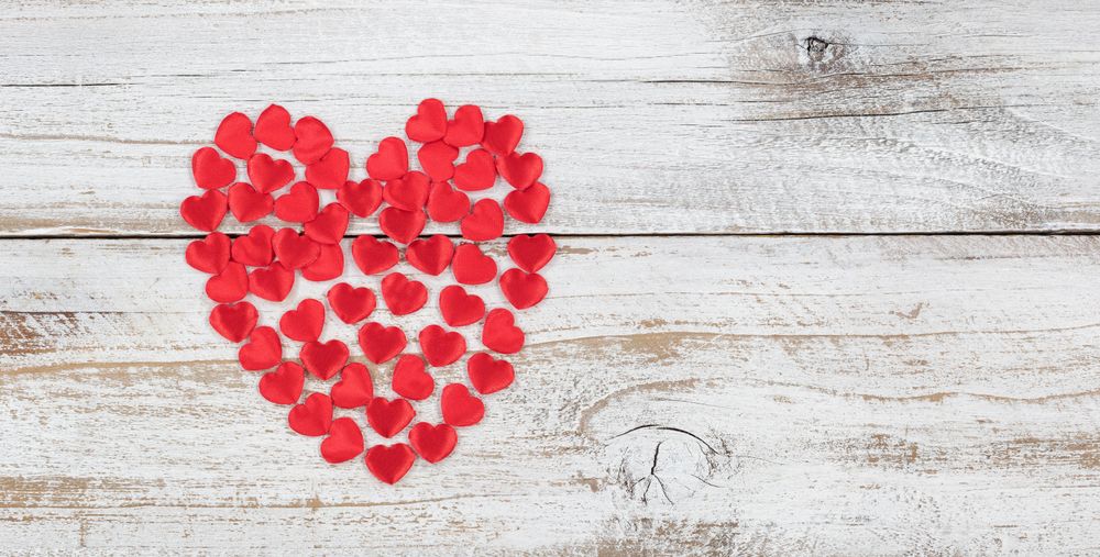 Filled red heart shapes on rustic wood