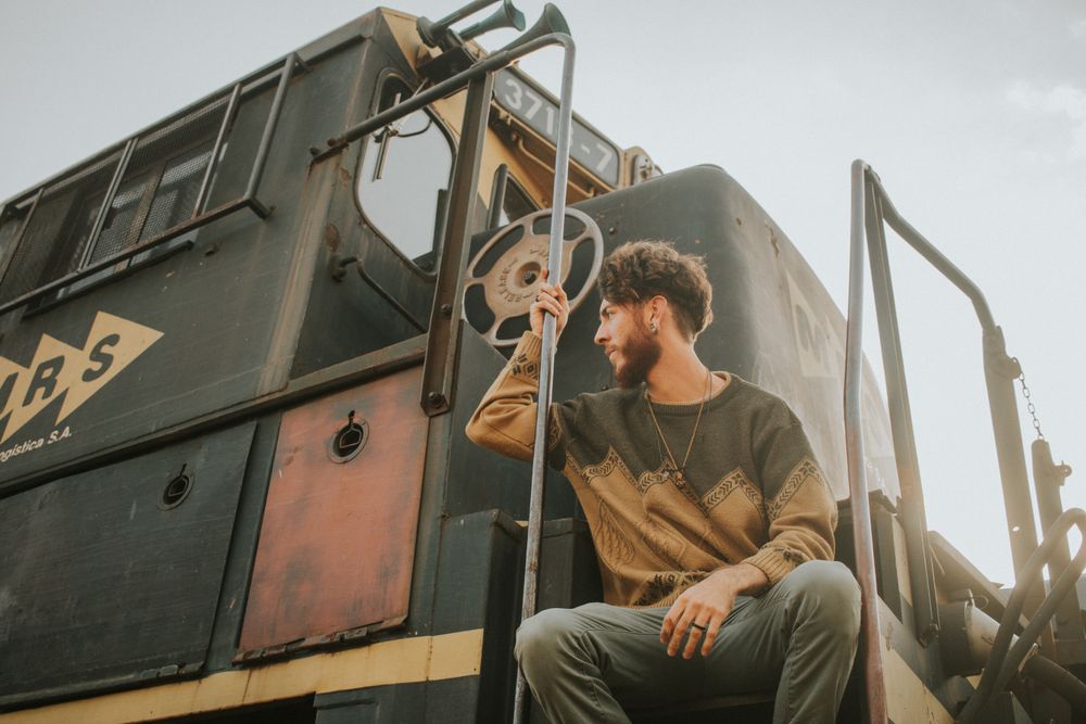 Man sitting beside train