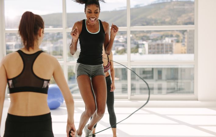 Women enjoying jumping rope workout at gym