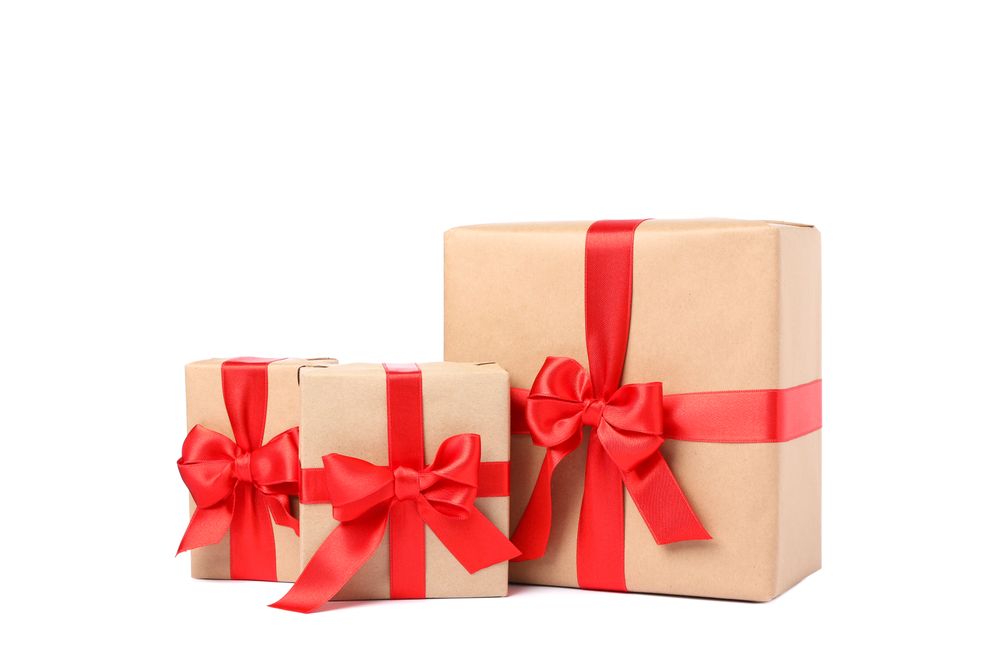 Beautiful gift boxes with red bow isolated on blank background