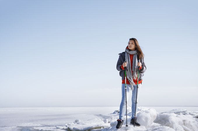 Young adult woman outdoors travelling in icy landscape