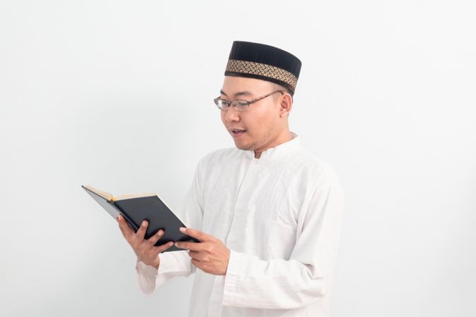 Asian Muslim man reading quran during Ramadan