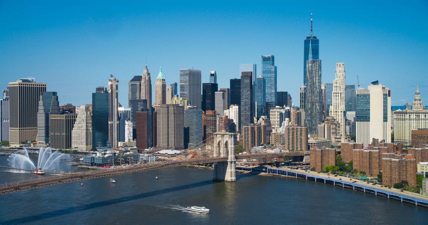 Aerial Cinematic Drone Scene Near Brooklyn Bridge with New York Skyscrapers Cityscape. Beautiful Sun Shining on a Warm Summer Day. Photo of Historic Architecture