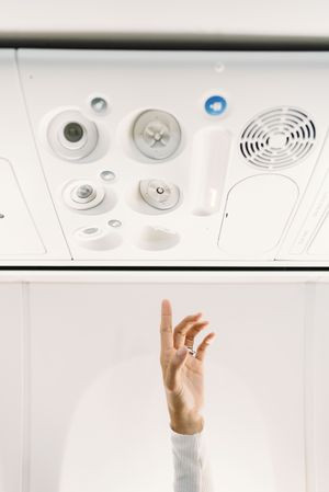 Person pressing button on panel up airplane